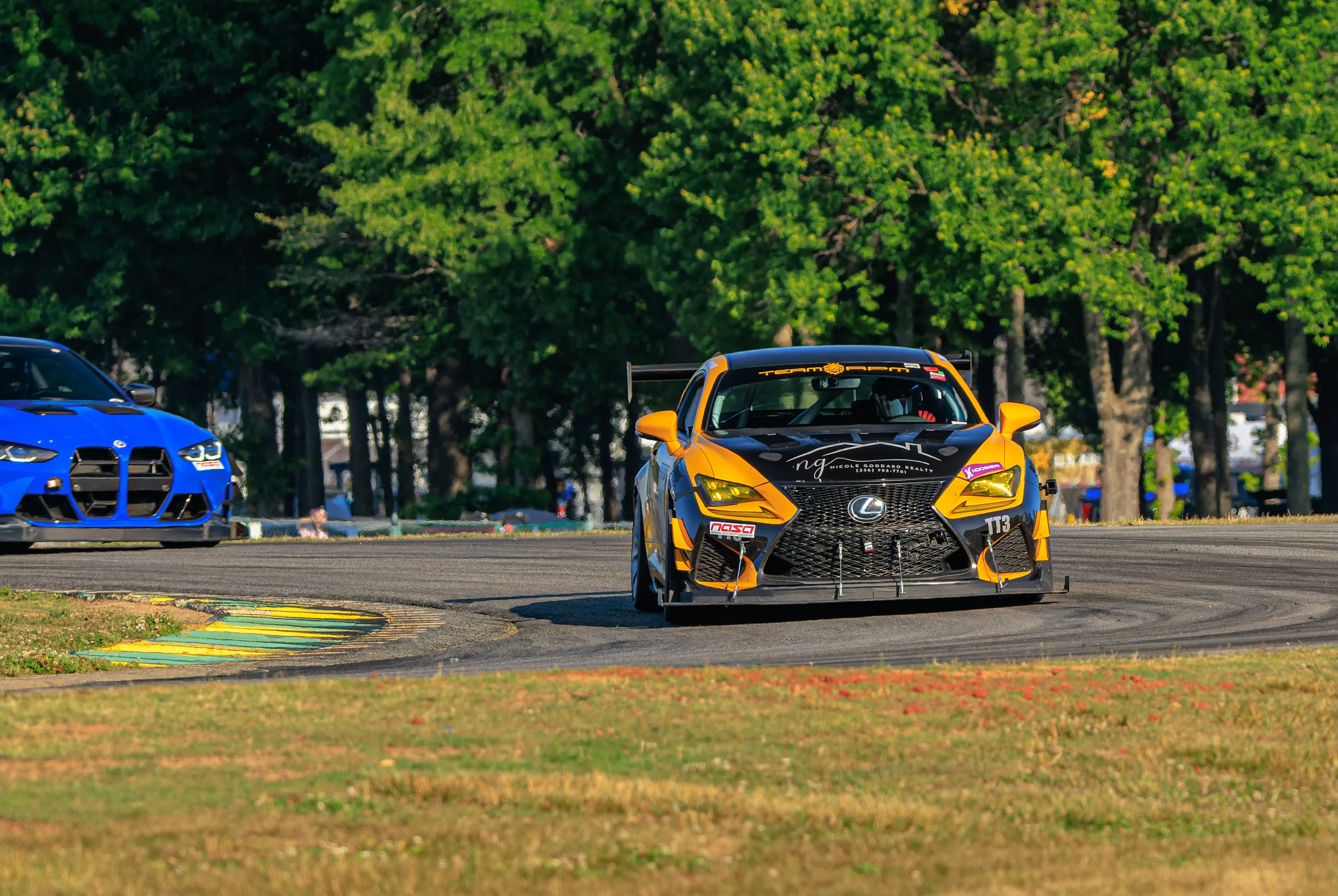 Close-up of the TEAM RPM Lexus RC F at speed, banner visible