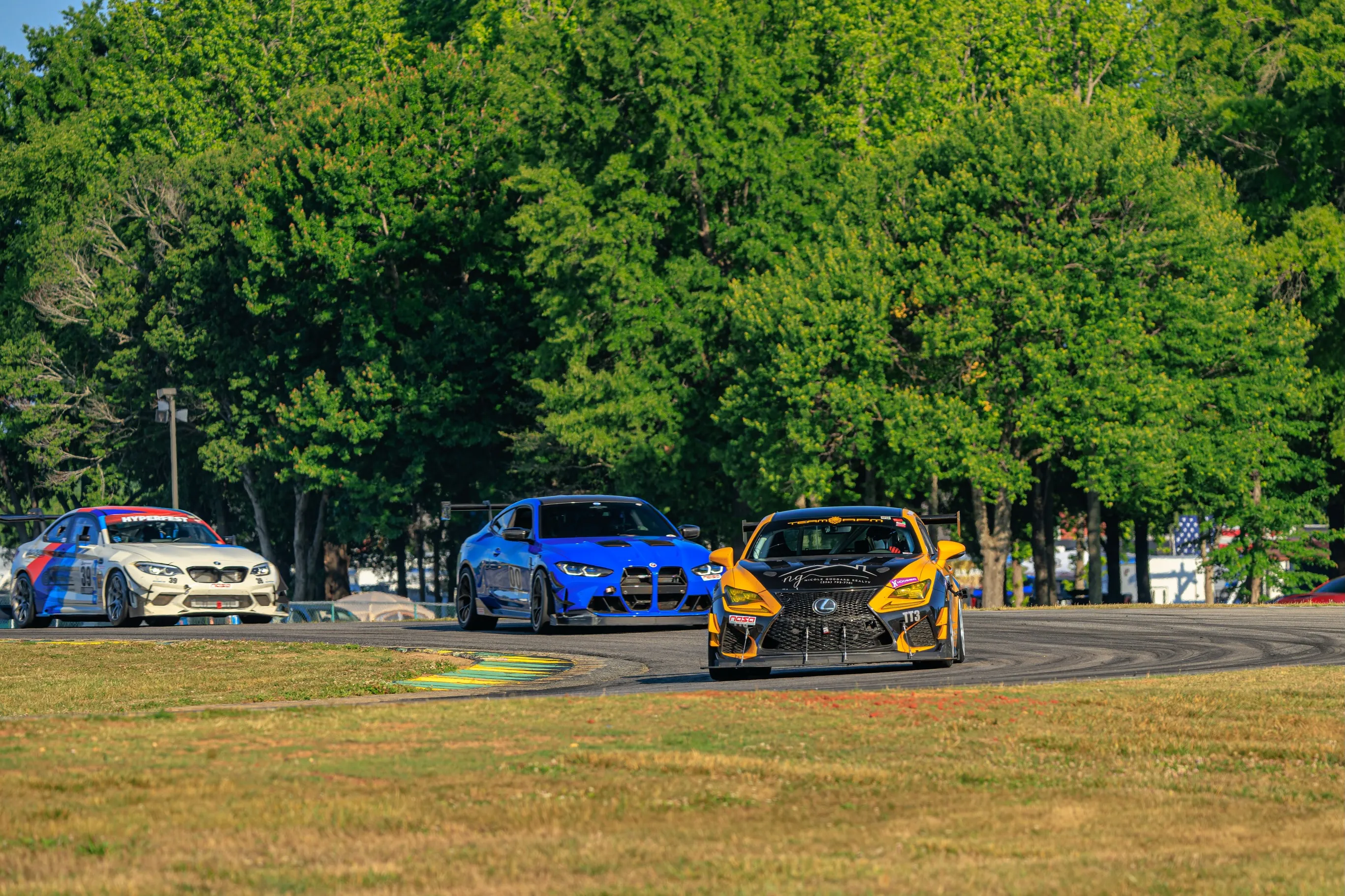TEAM RPM Lexus RC F leading BMWs through a corner at VIR