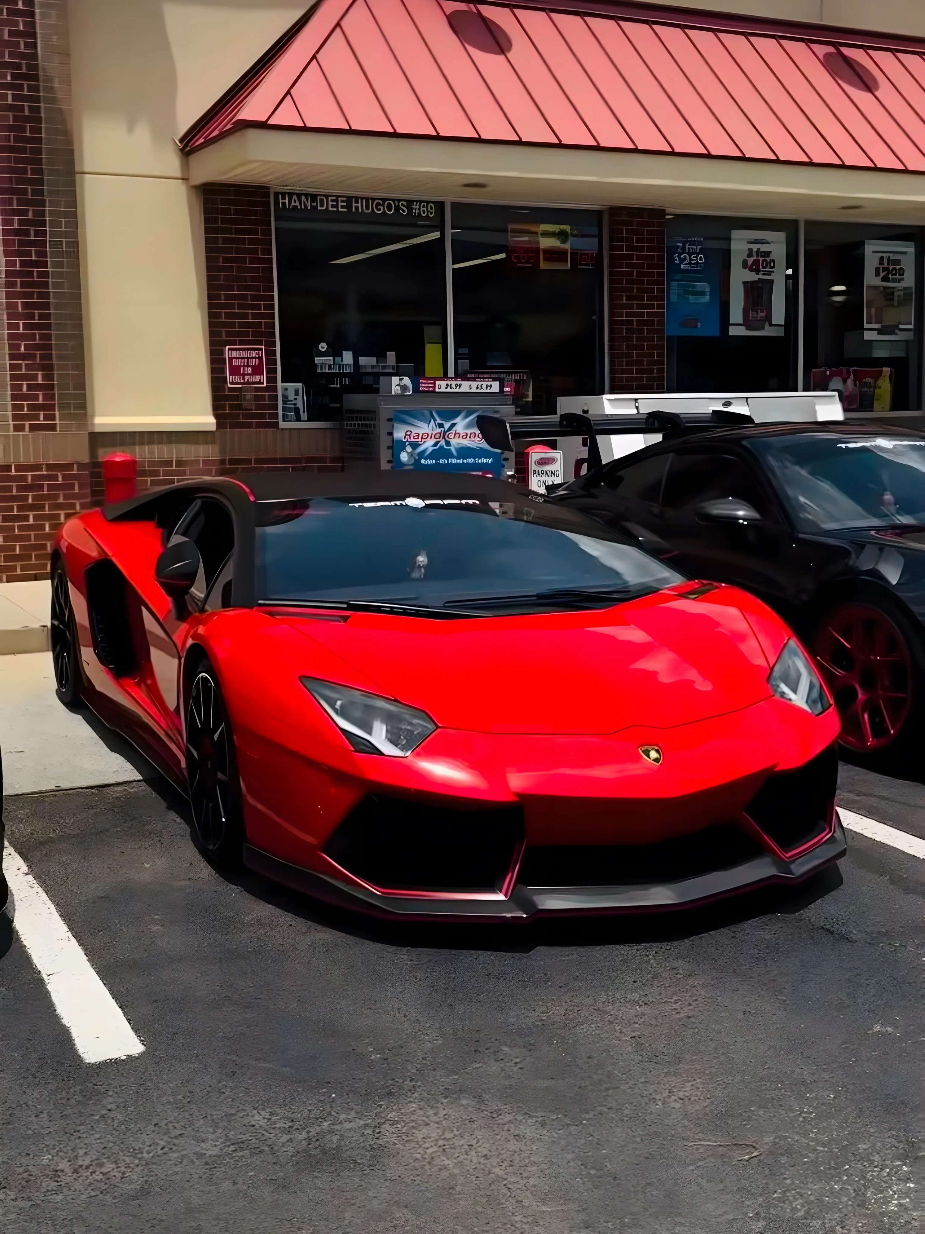 Red Aventador at a gas station meet