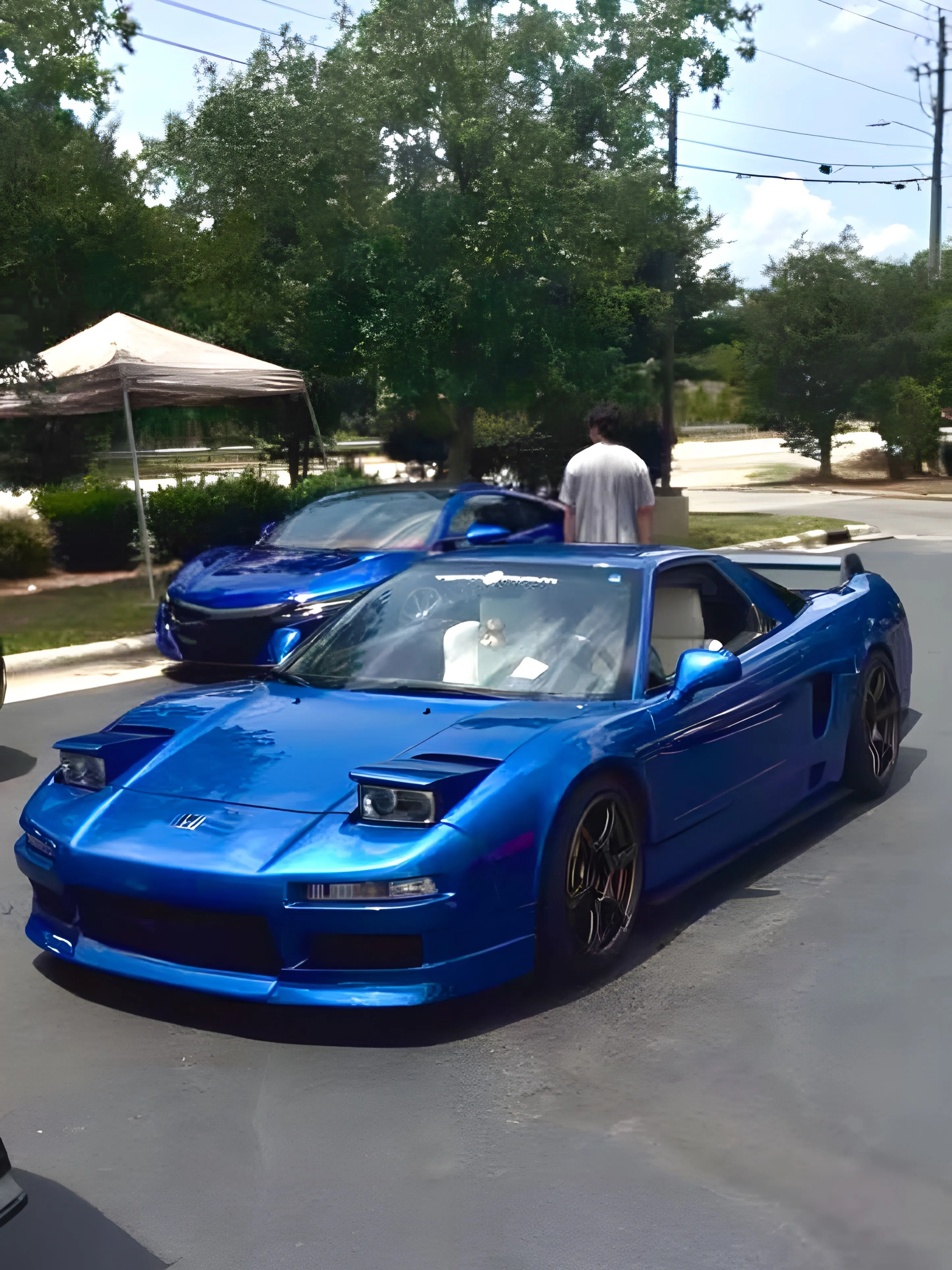 Blue Honda NSX arriving at a car meet