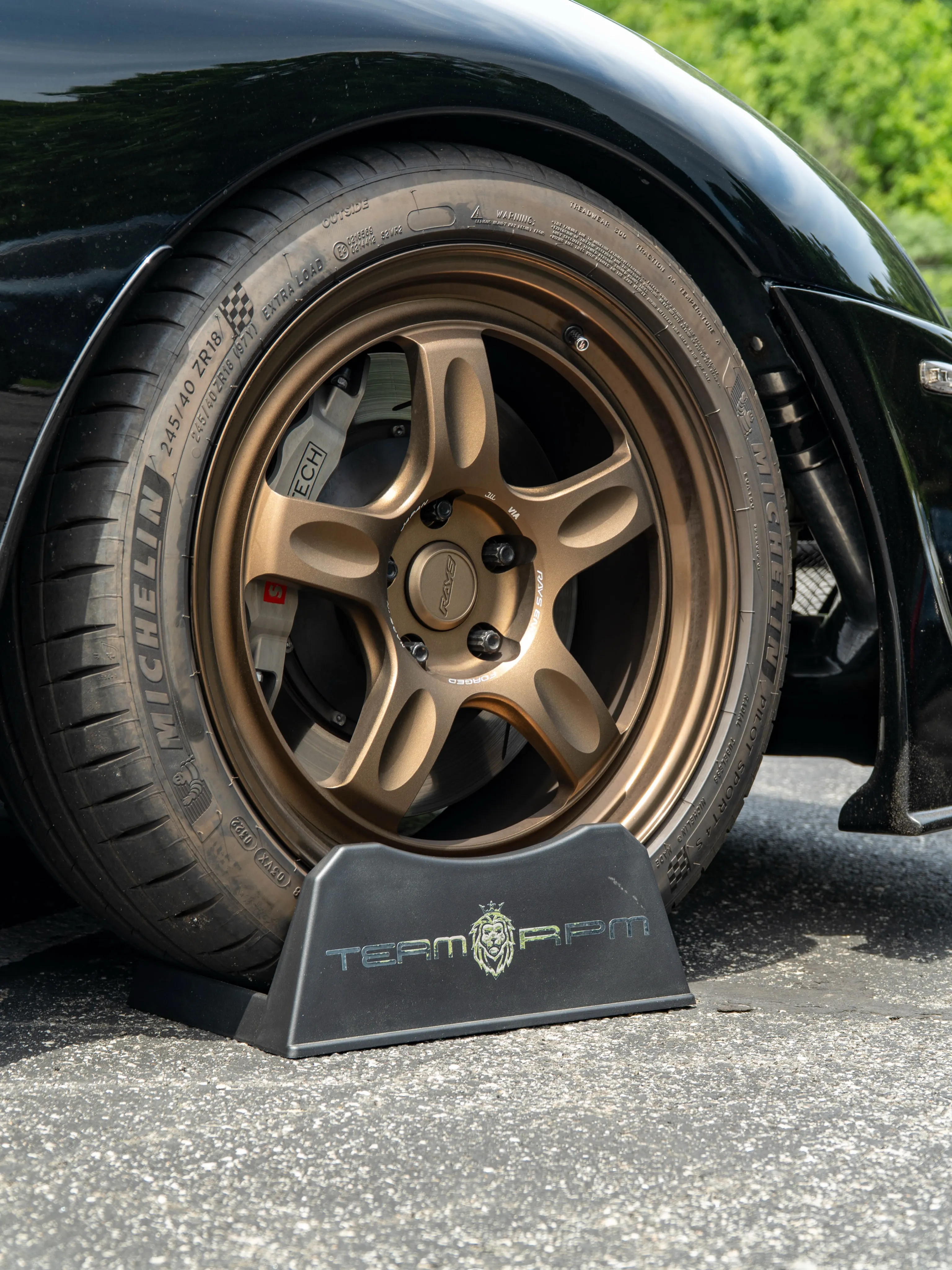 Bronze wheel close-up with TEAM RPM wheel chock