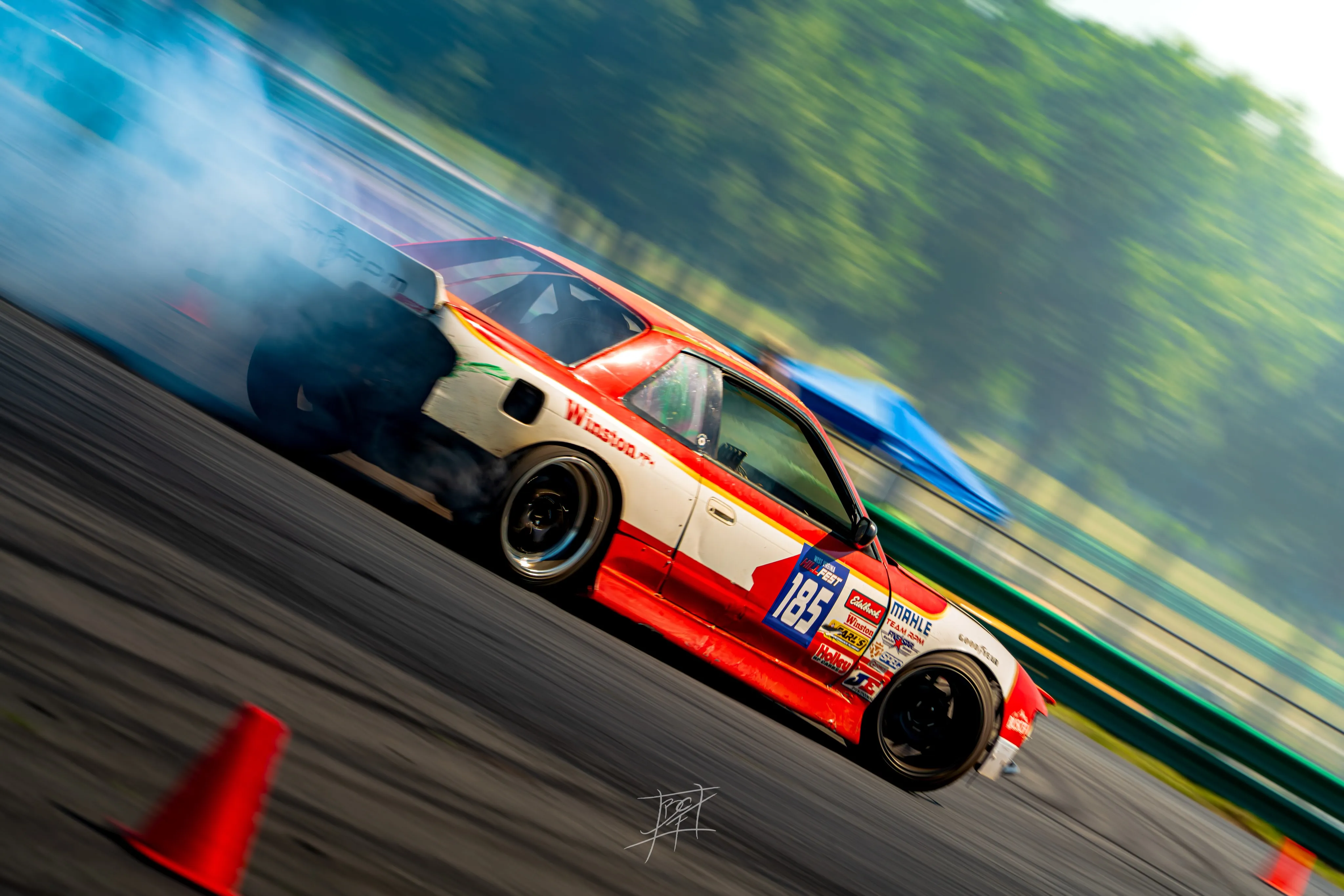 Winston-livery number 185 S-chassis mid-drift at HyperFest, VIR