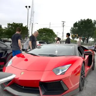 TEAM RPM members gathered near a red Aventador at a meet